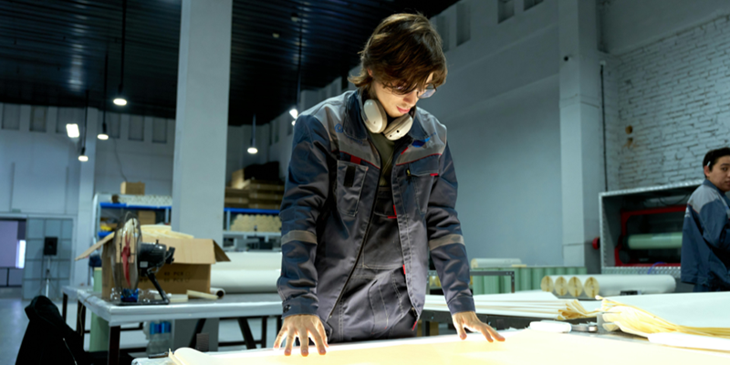 Man examines blueprint in warehouse